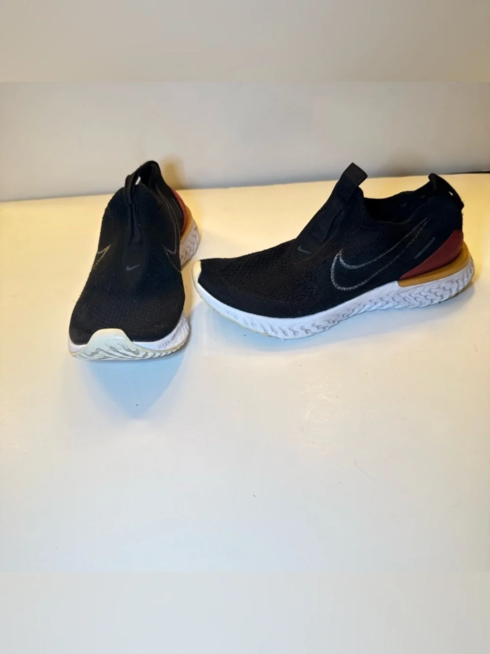 Nike Black Slip-On Athletic Shoes with Orange Heel Accent